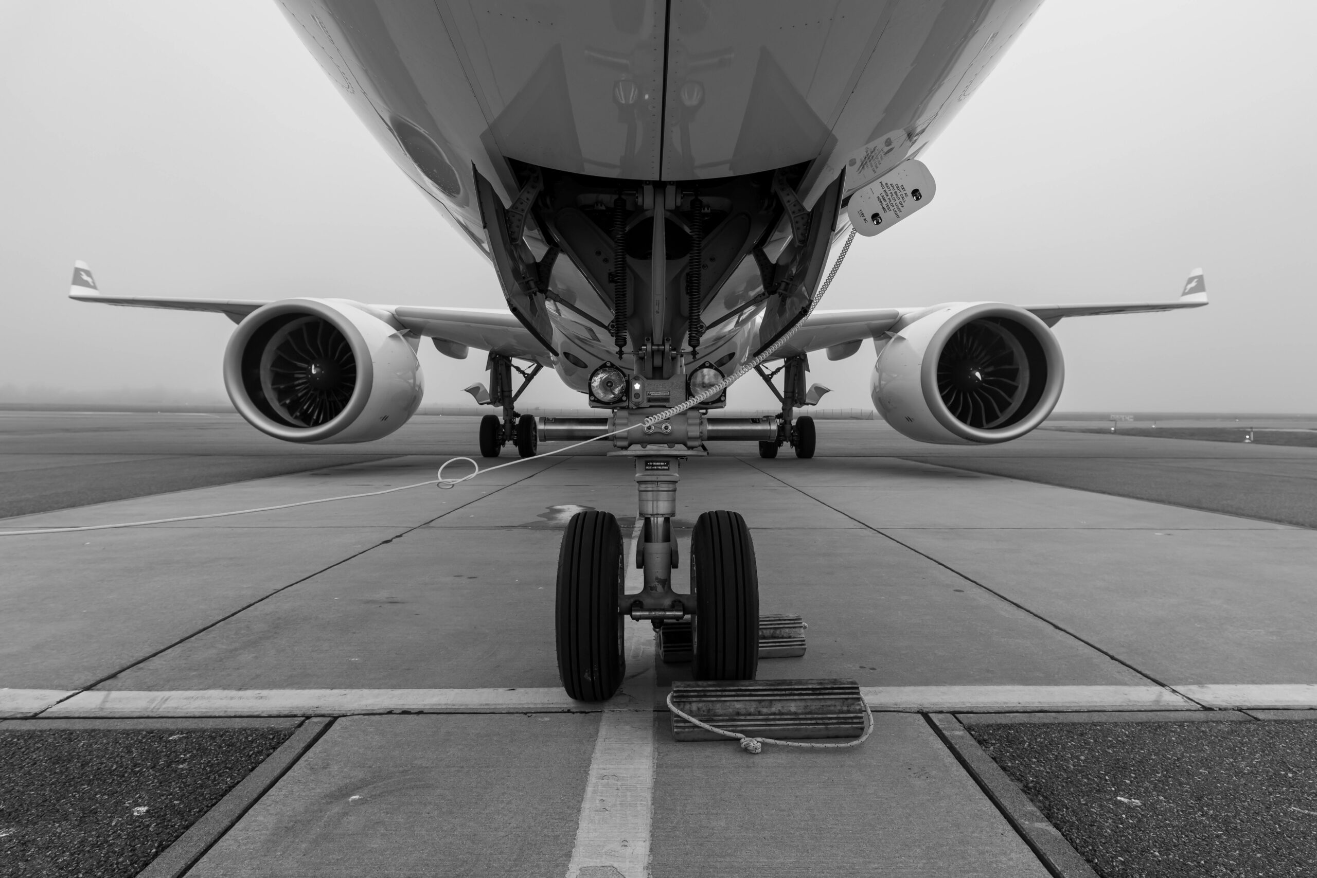 Undercarriage of an airplane on a foggy runway – JERTRANS